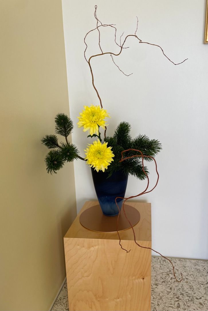 Seasonal ikebana arrangement in a low container