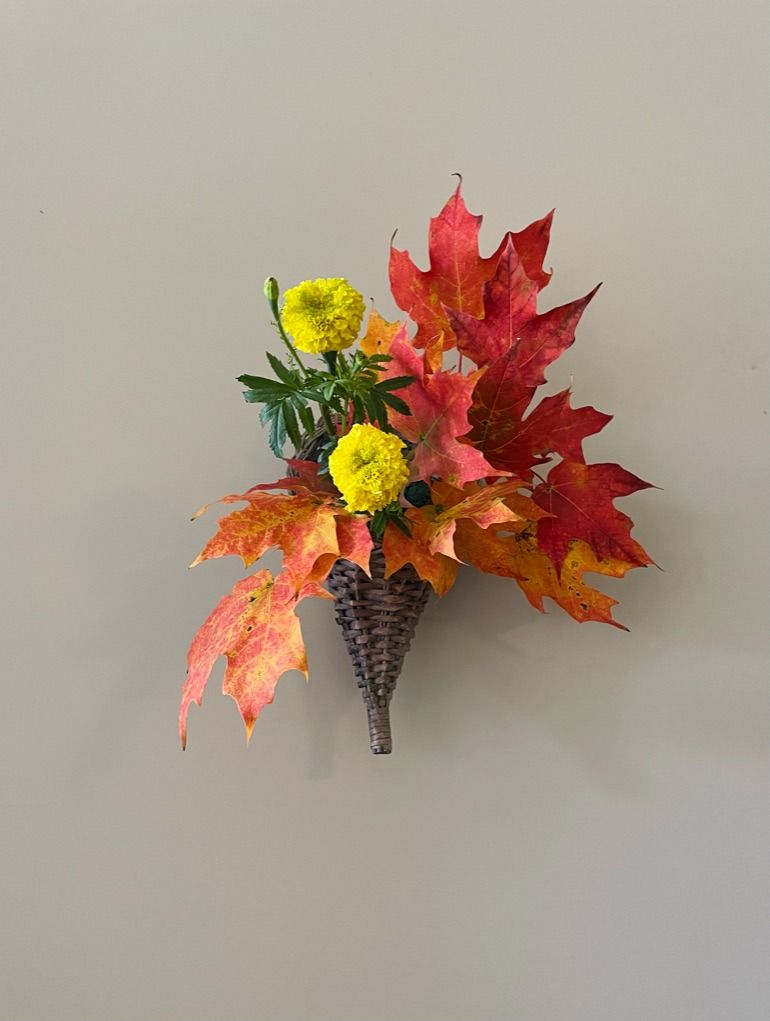Ikebana arrangement with bright seasonal flowers