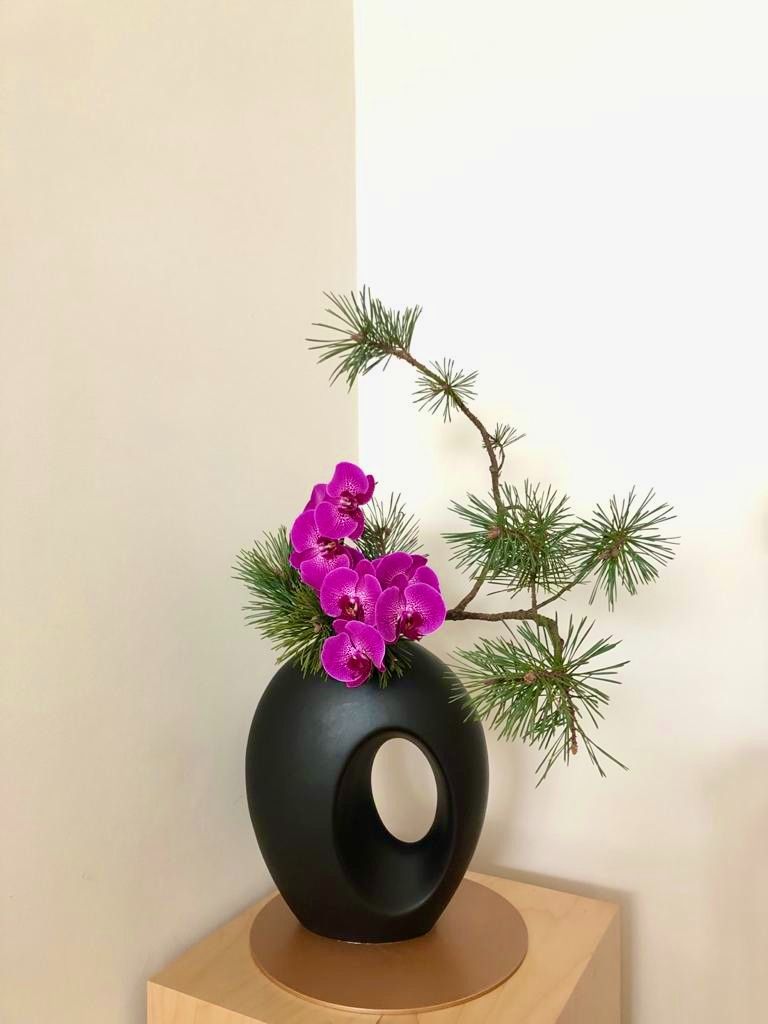 Ikebana arrangement with sculptural branch structure